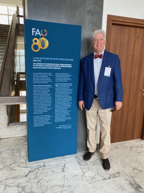 Executive Director Roberts standing next to a placard inscription